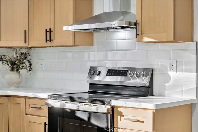 a kitchen with stainless steel appliances a sink stove and cabinets