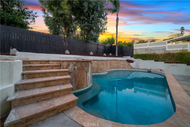 a swimming pool with outdoor seating