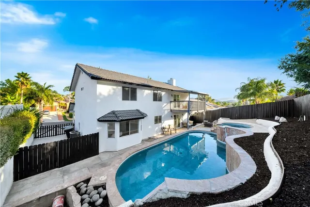a view of a patio with table and chairs potted plants with wooden fence