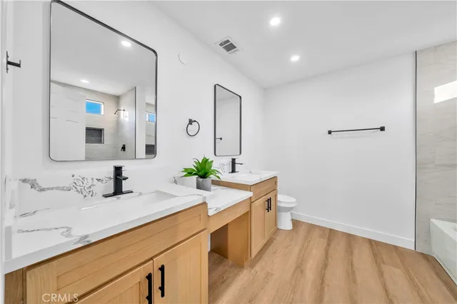a spacious bedroom with a bed and a chandelier
