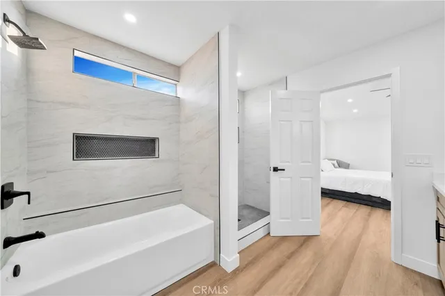 a spacious bedroom with a bed and a couch