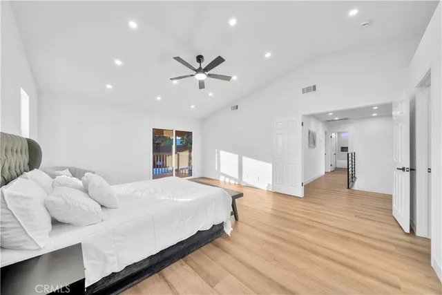 a spacious bedroom with a bed and a large window