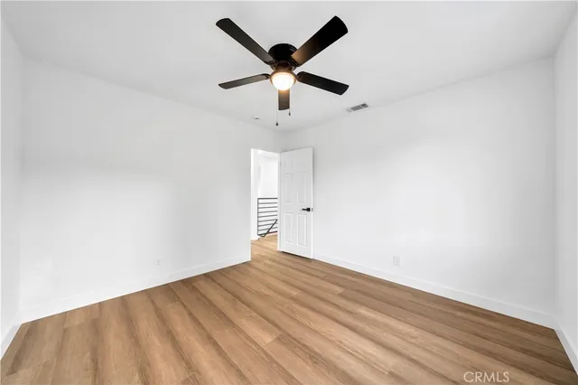 a front view of house with yard and trees in the background