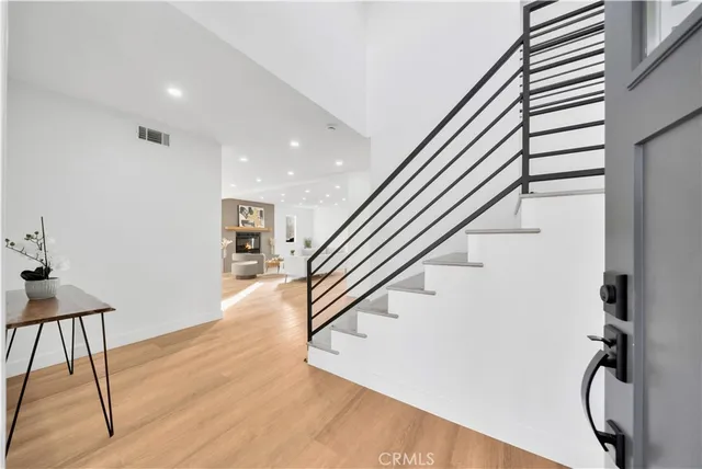 a living room with furniture and kitchen view