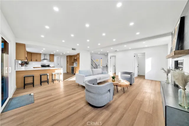 a large kitchen with kitchen island a sink a center island stainless steel appliances and a cabinets