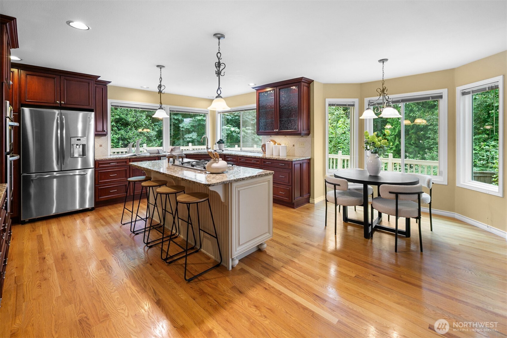 16116 68th Avenue West Edmonds, WA 98026 - Photo 6 of 40 a kitchen with stainless steel appliances granite countertop a table chairs stove and kitchen view