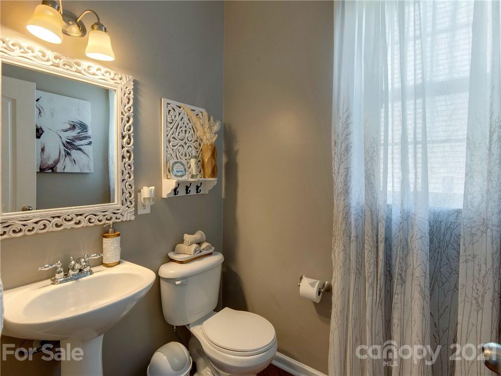 2405 Coltsgate Road Waxhaw, NC 28173 - Photo 11 of 48 a bathroom with a toilet sink and mirror