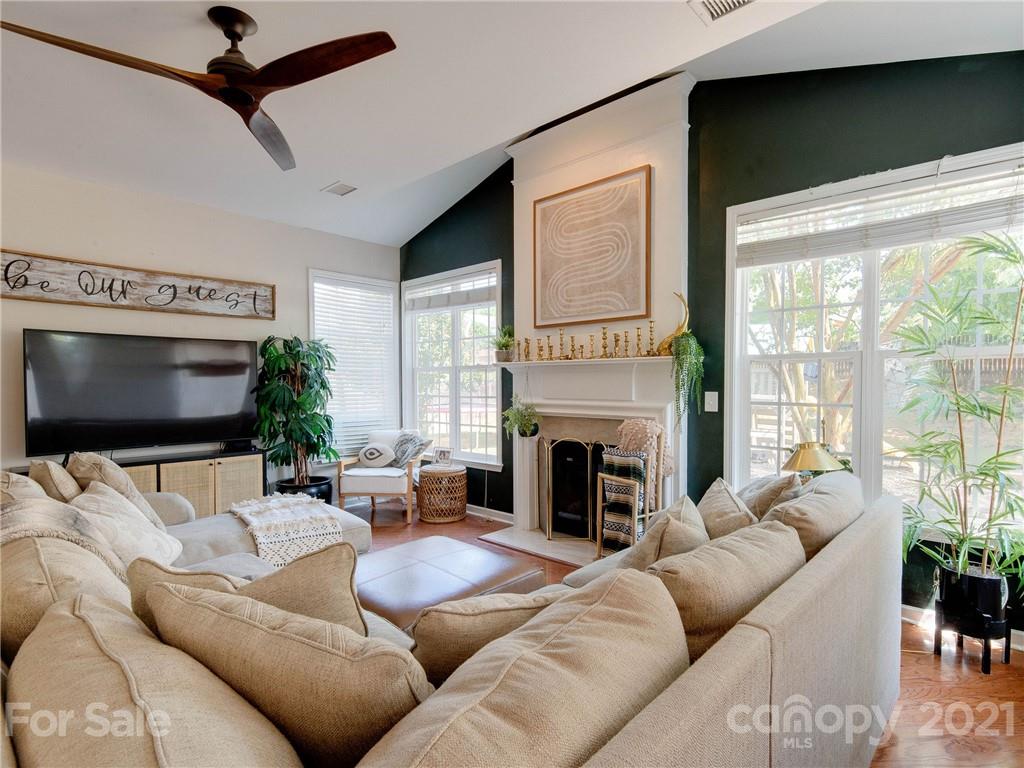 2405 Coltsgate Road Waxhaw, NC 28173 - Photo 15 of 48 a living room with furniture a flat screen tv and a fireplace