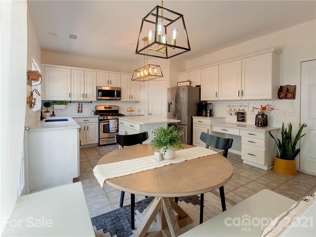 2405 Coltsgate Road Waxhaw, NC 28173 - Photo 19 of 48 a view of kitchen with cabinets table and chairs