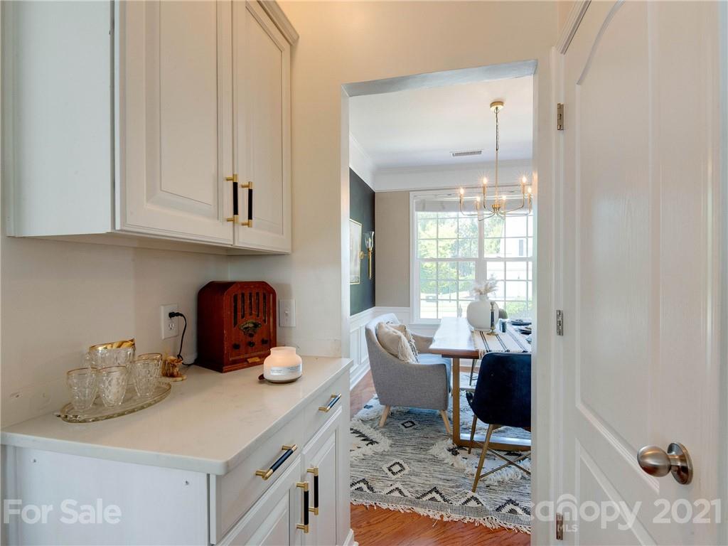 2405 Coltsgate Road Waxhaw, NC 28173 - Photo 22 of 48 a kitchen with granite countertop a sink cabinets and living room view