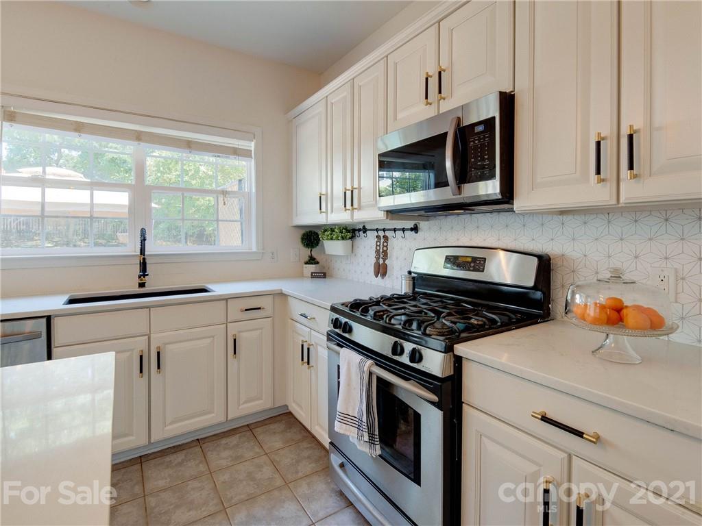 2405 Coltsgate Road Waxhaw, NC 28173 - Photo 25 of 48 a kitchen with stainless steel appliances granite countertop a sink and a stove
