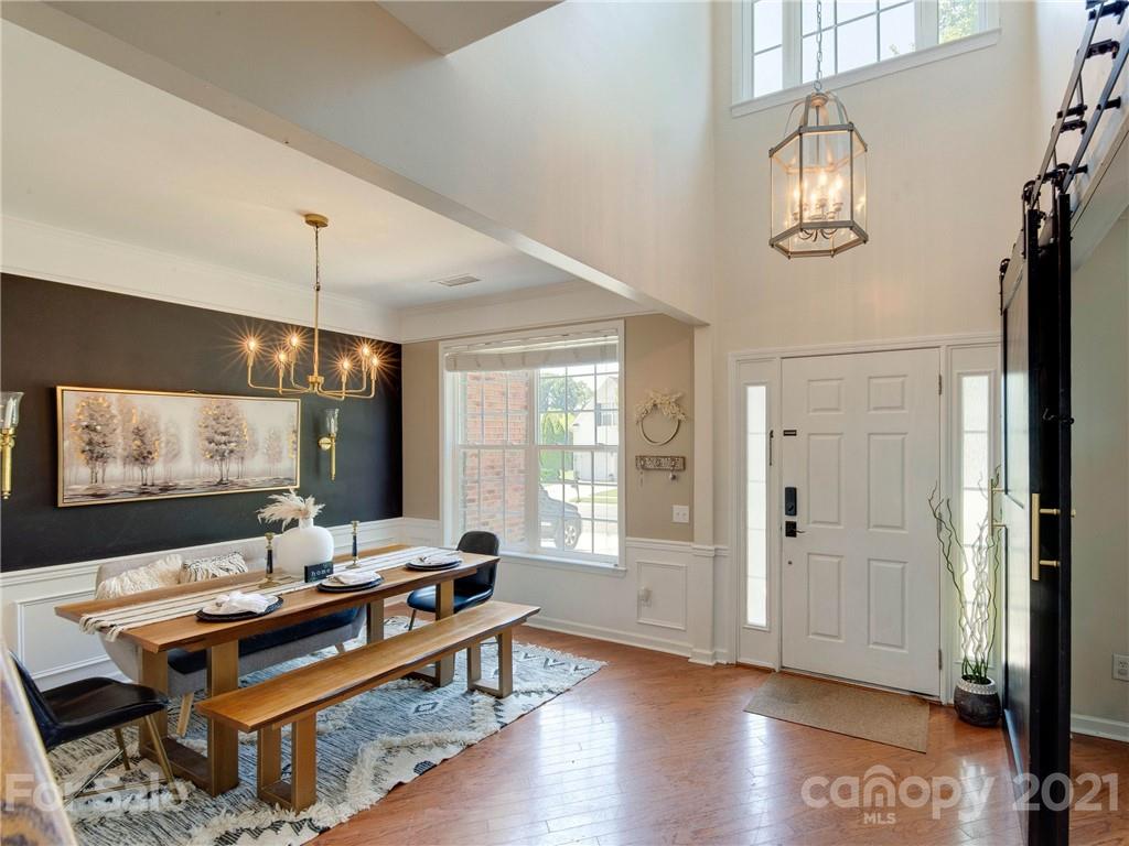 2405 Coltsgate Road Waxhaw, NC 28173 - Photo 4 of 48 a view of a workspace with furniture and a flat screen tv