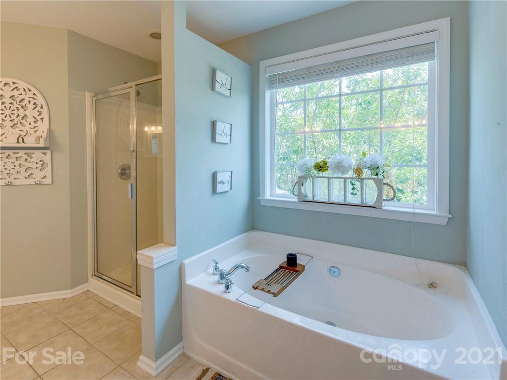 2405 Coltsgate Road Waxhaw, NC 28173 - Photo 34 of 48 a bathroom with a bathtub and a shower