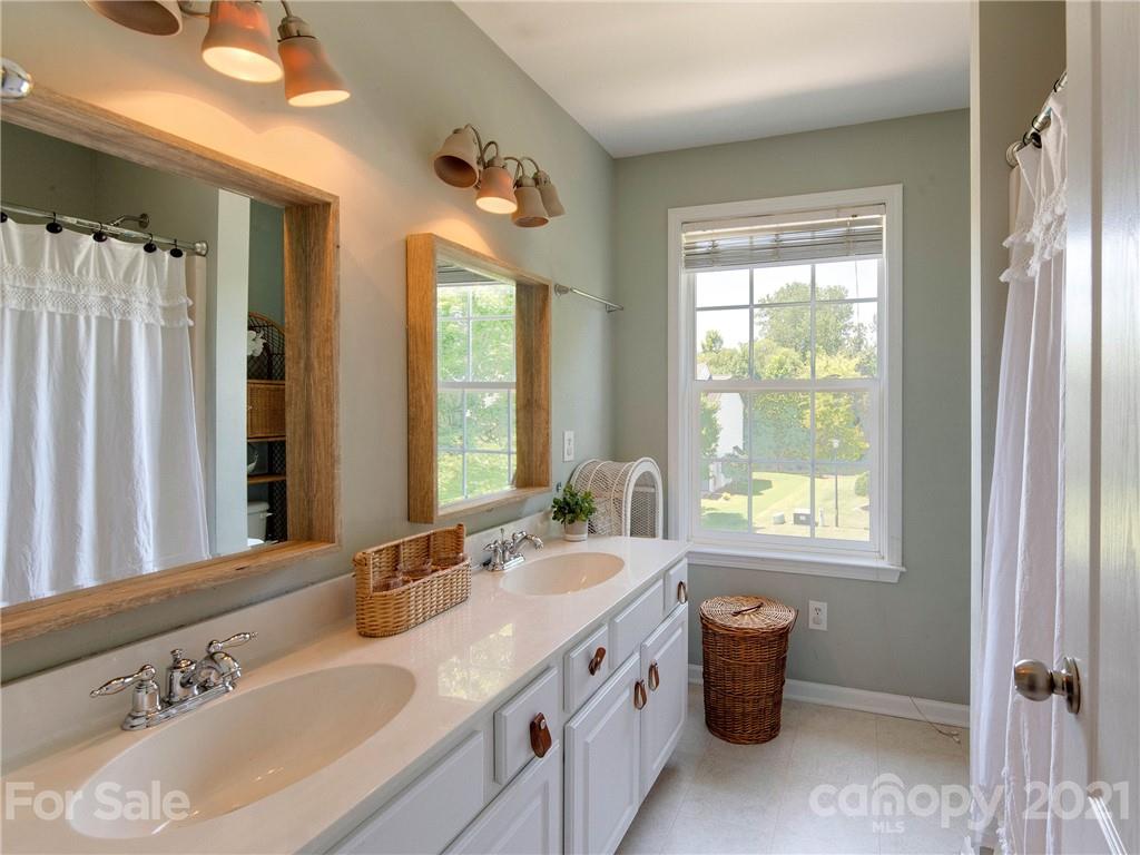 2405 Coltsgate Road Waxhaw, NC 28173 - Photo 37 of 48 a bathroom with a tub sink and mirror