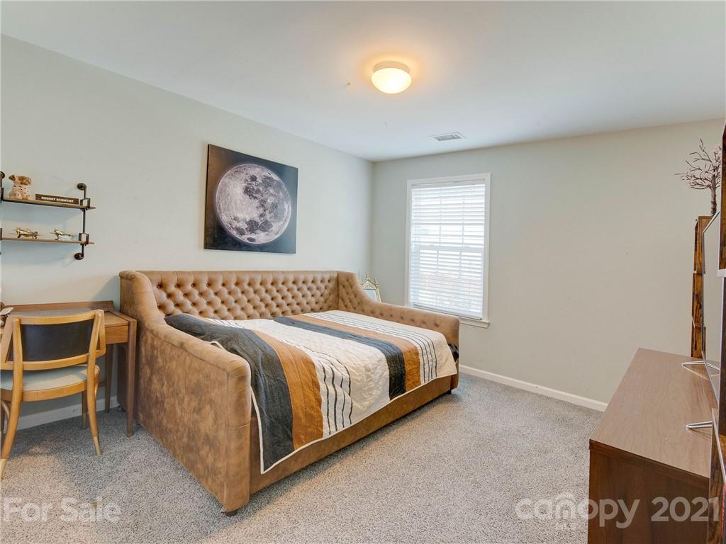 2405 Coltsgate Road Waxhaw, NC 28173 - Photo 40 of 48 a spacious bedroom with a bed and a desk