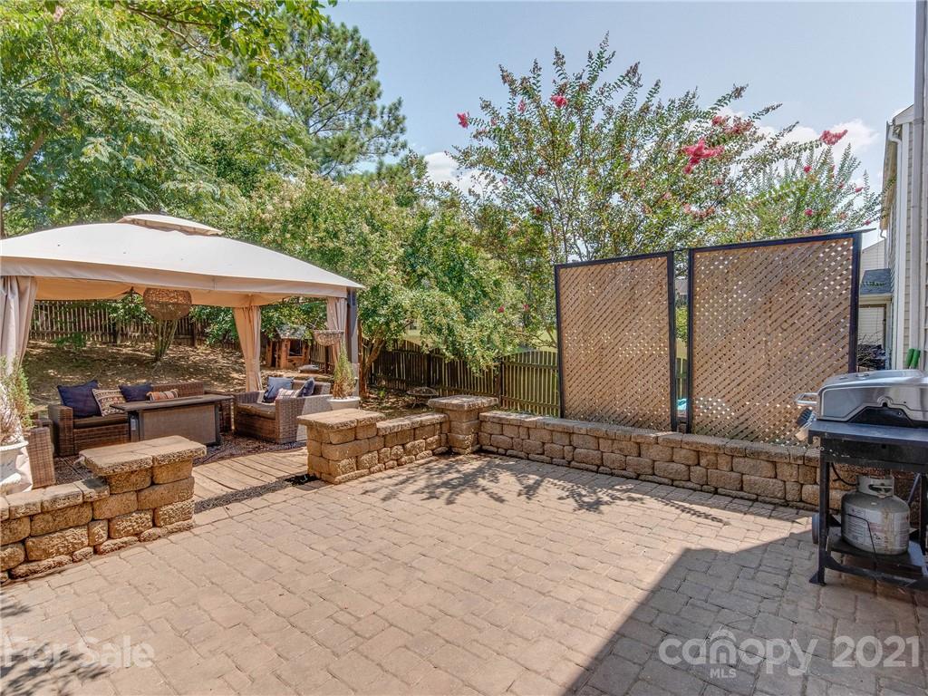 2405 Coltsgate Road Waxhaw, NC 28173 - Photo 42 of 48 a view of backyard with outdoor seating and trees