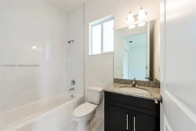 a bathroom with a sink a toilet and bathtub