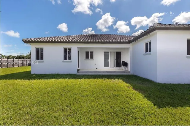 a house view with swimming pool and garden space