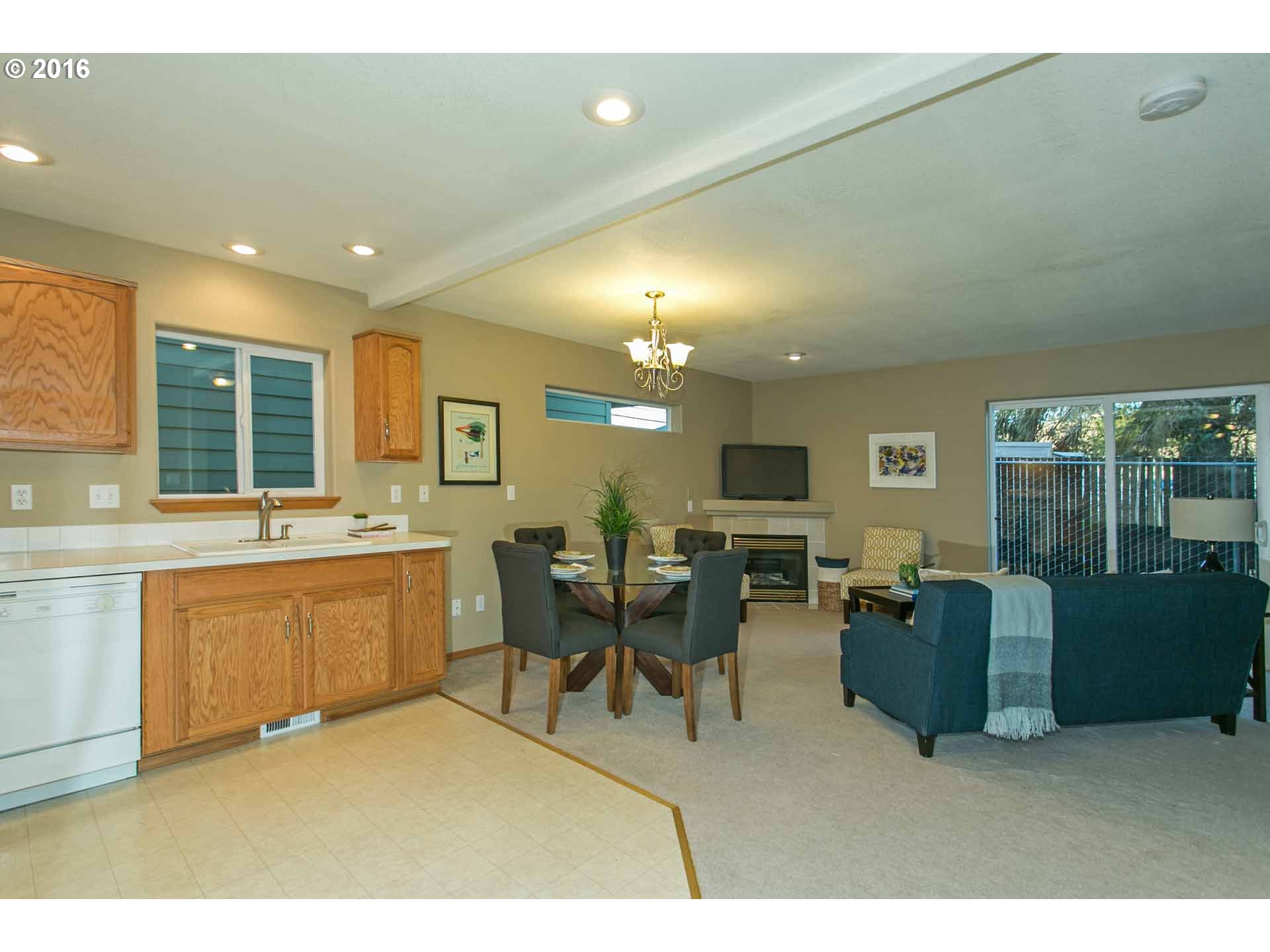1908 Southeast 122nd Avenue Portland, OR 97233 - Photo 2 of 11 a living room with furniture a flat screen tv and a large window