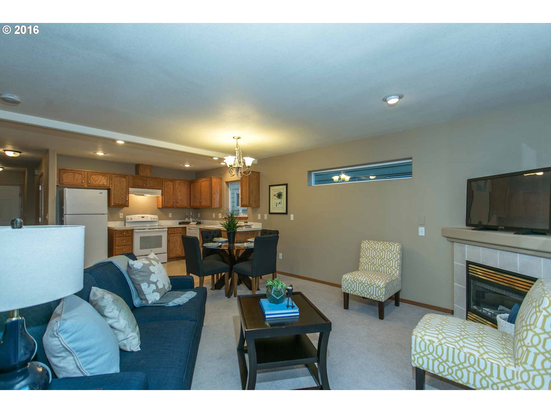 1908 Southeast 122nd Avenue Portland, OR 97233 - Photo 3 of 11 a living room with furniture a flat screen tv and a fireplace