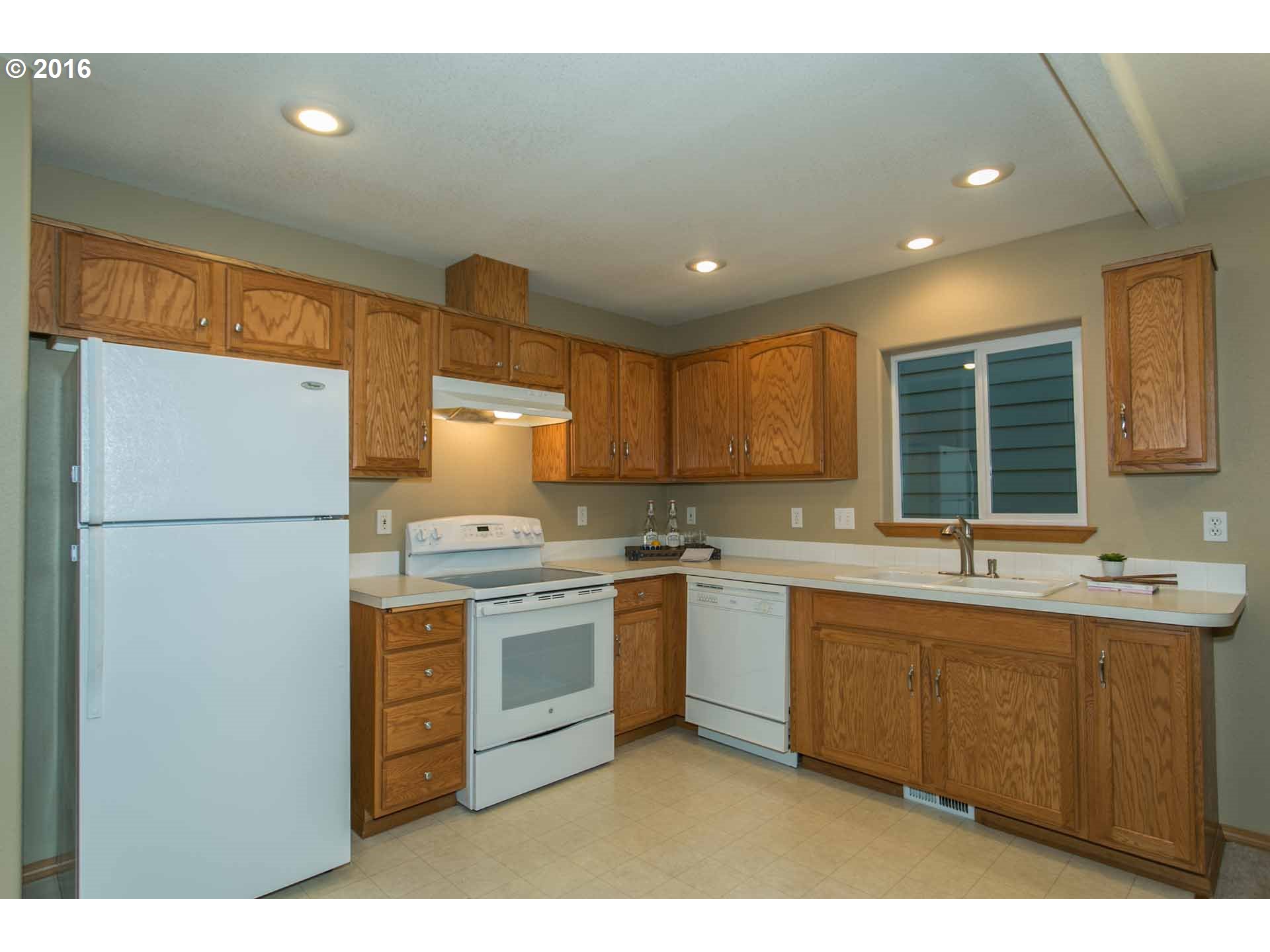 1908 Southeast 122nd Avenue Portland, OR 97233 - Photo 5 of 11 a kitchen with a sink stainless steel appliances and cabinets