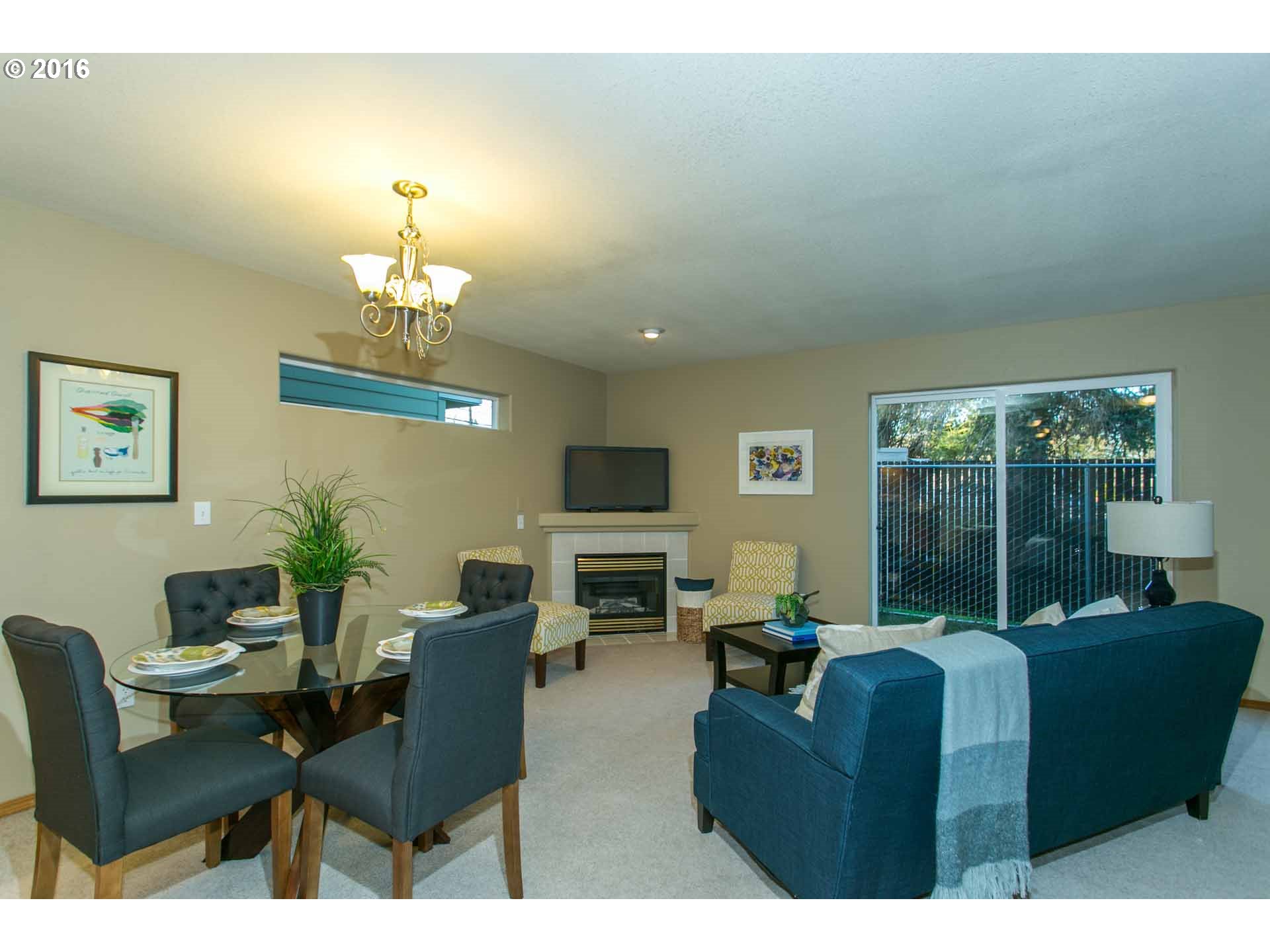 1908 Southeast 122nd Avenue Portland, OR 97233 - Photo 6 of 11 a living room with furniture and a chandelier