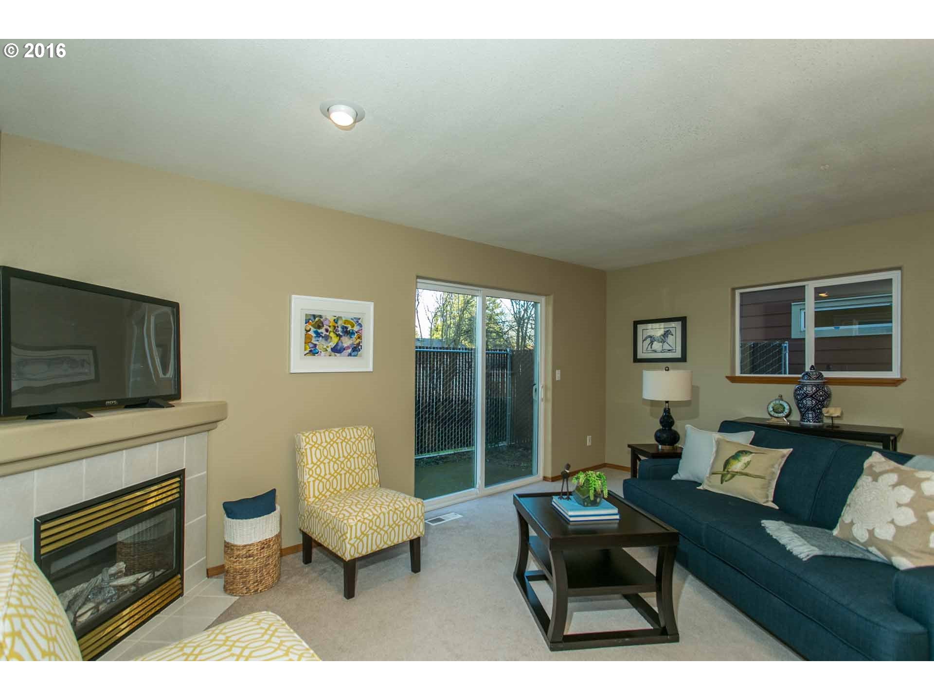 1908 Southeast 122nd Avenue Portland, OR 97233 - Photo 7 of 11 a living room with furniture a flat screen tv and a fireplace