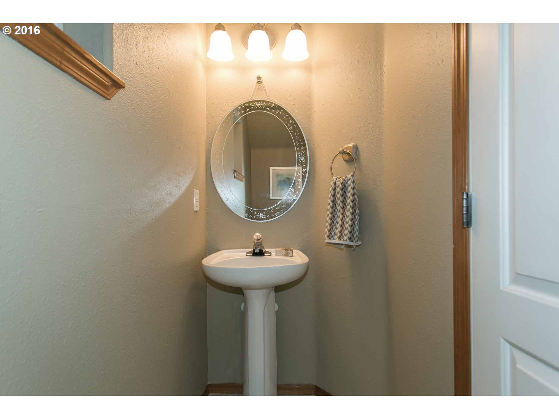 1908 Southeast 122nd Avenue Portland, OR 97233 - Photo 9 of 11 a bathroom with a sink and a mirror