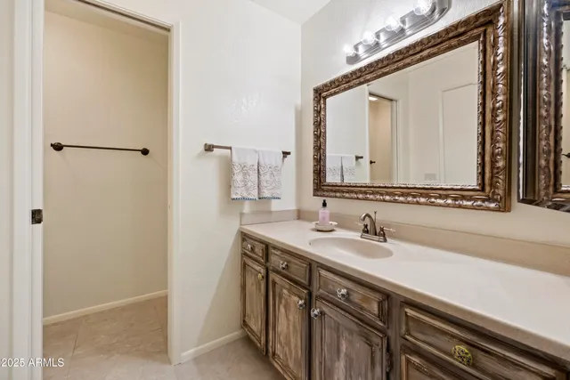 a bathroom with a sink a mirror and a shower