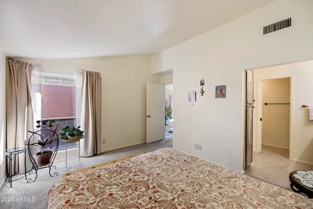 a bedroom with a bed and a dresser