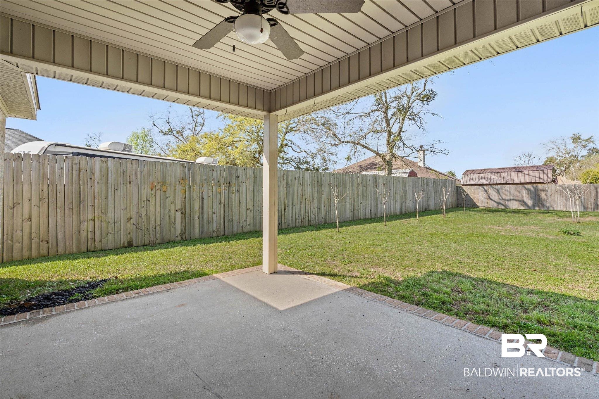 101 Washington Boulevard Foley, AL 36535 - Photo 25 of 32 Fenced backyard featuring a ceiling fan and a patio