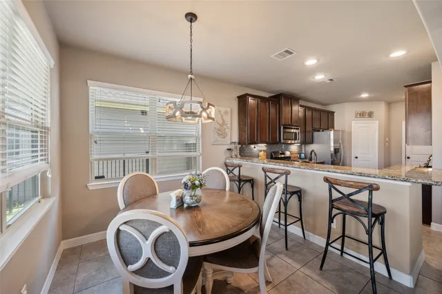 a spacious bedroom with a bed and a flat screen tv