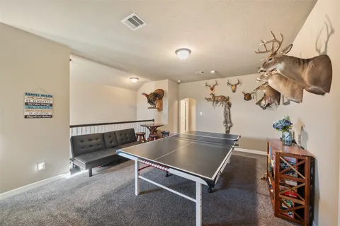 a room with gym equipment and a chandelier