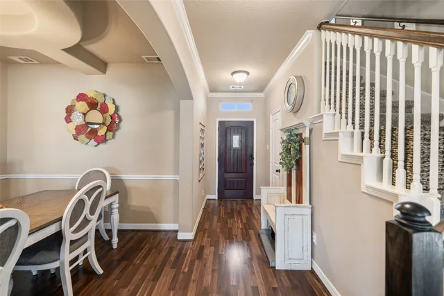 a view of a dining room with furniture a chandelier and wooden floor