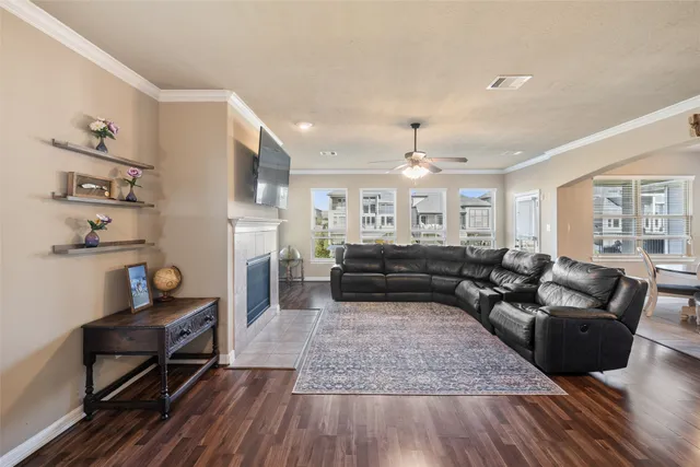 a living room with furniture a fireplace and a flat screen tv