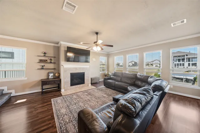 a living room with furniture a fireplace and a flat screen tv