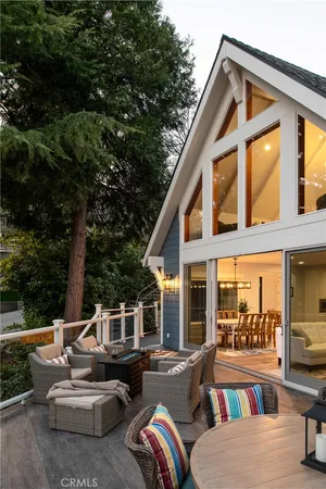 a view of a patio with couches table and chairs and potted plants
