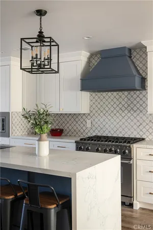 a kitchen with a sink a stove and cabinets