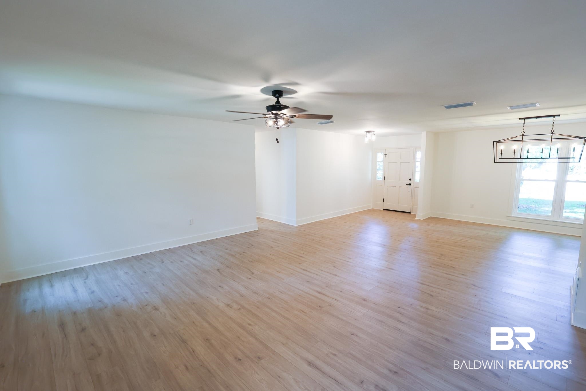 12190 Pecan Grove Street Magnolia Springs, AL 36555 - Photo 8 of 45 Unfurnished living room featuring light hardwood / wood-style flooring and ceiling fan