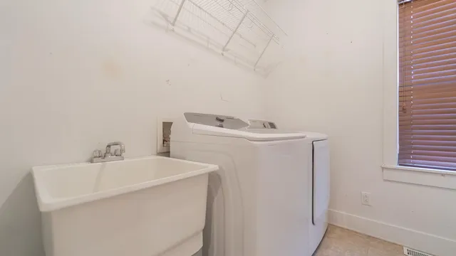 a bathroom with a granite countertop toilet and sink