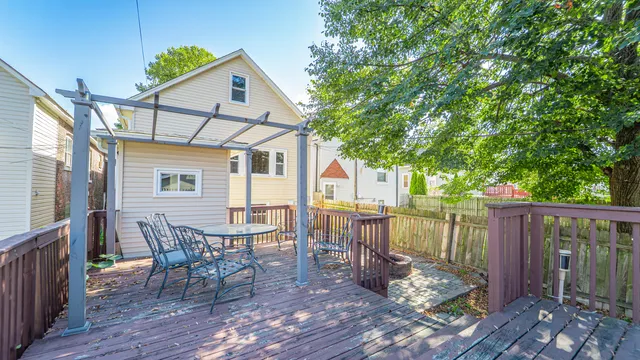 a view of a porch with a floor to ceiling window next to a yard