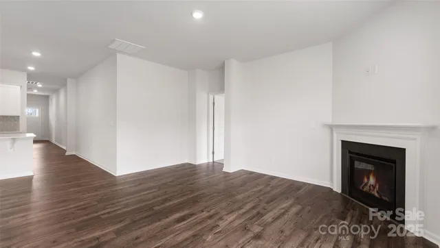 a view of a room with wooden floor and a fireplace