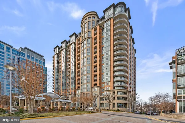 a view of a tall building next to a road
