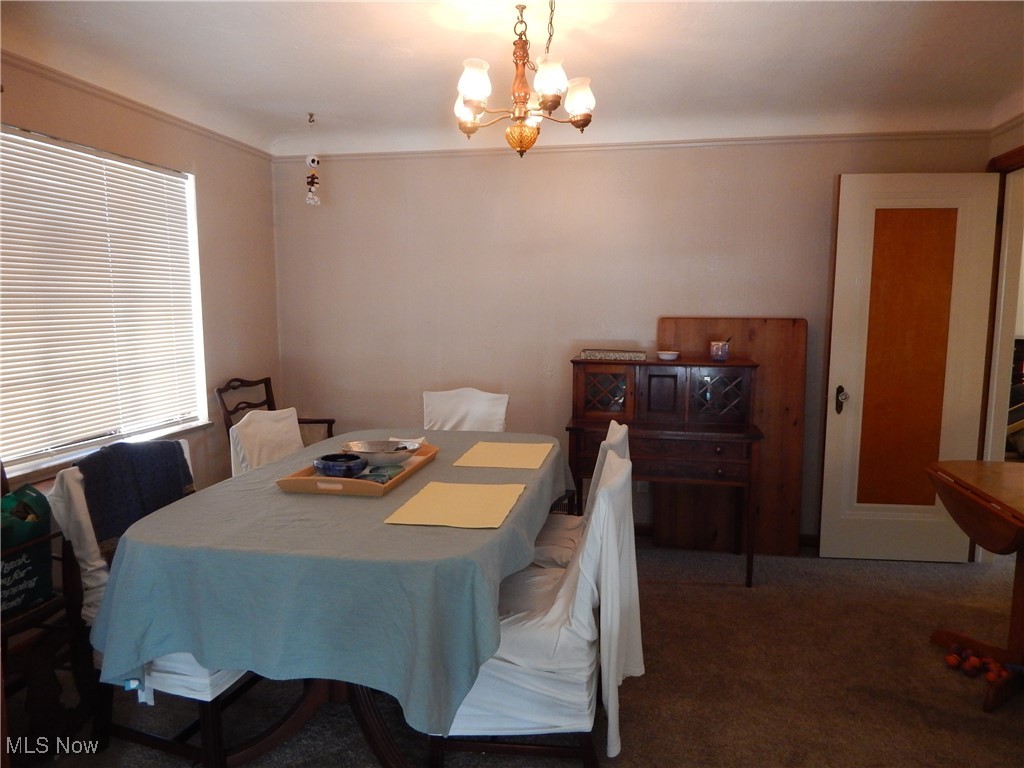 3685 Warren Road Cleveland, OH 44111 - Photo 12 of 26 Dining space showcased by a generous sized Window, with newer carpet over Hardwood floors, and an inviting chandelier,