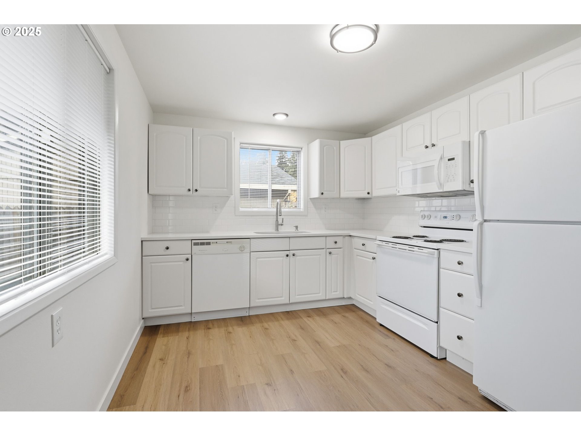 117 North 9th Avenue Ridgefield, WA 98642 - Photo 11 of 47 a kitchen with white cabinets and white appliances