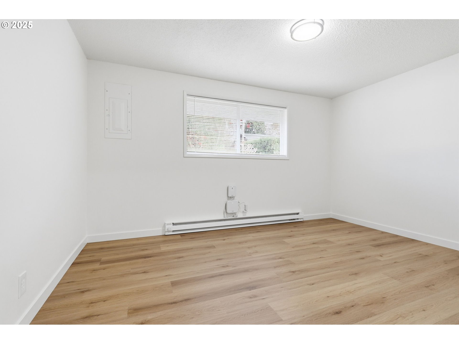 117 North 9th Avenue Ridgefield, WA 98642 - Photo 16 of 47 a view of an empty room with wooden floor