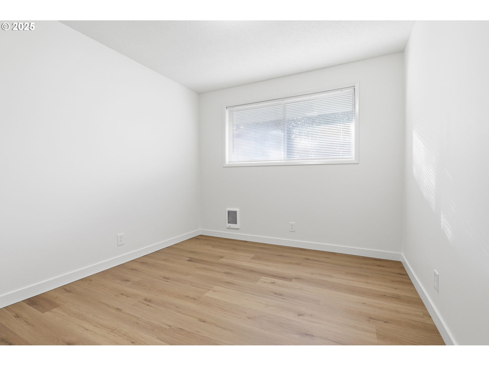 117 North 9th Avenue Ridgefield, WA 98642 - Photo 18 of 47 an empty room with wooden floor and windows