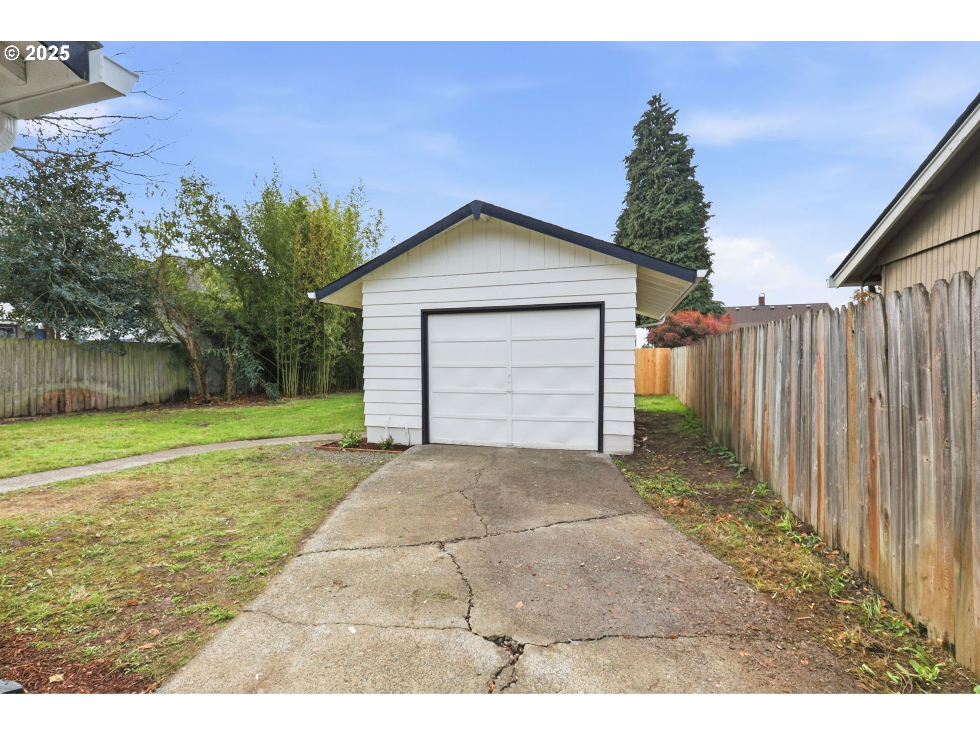 117 North 9th Avenue Ridgefield, WA 98642 - Photo 27 of 47 a view of backyard of house with garage and large trees