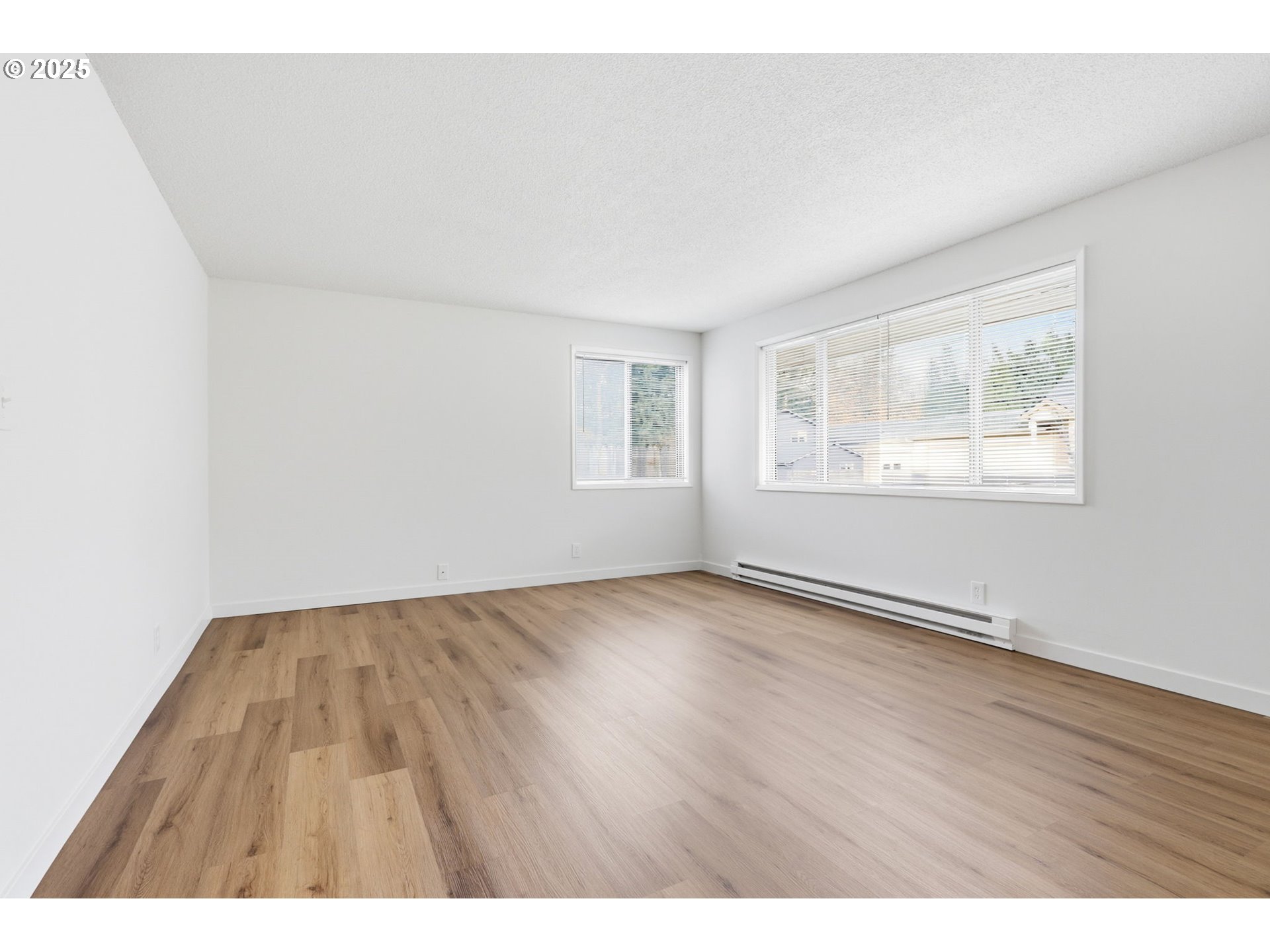 117 North 9th Avenue Ridgefield, WA 98642 - Photo 6 of 47 a view of an empty room with wooden floor and window