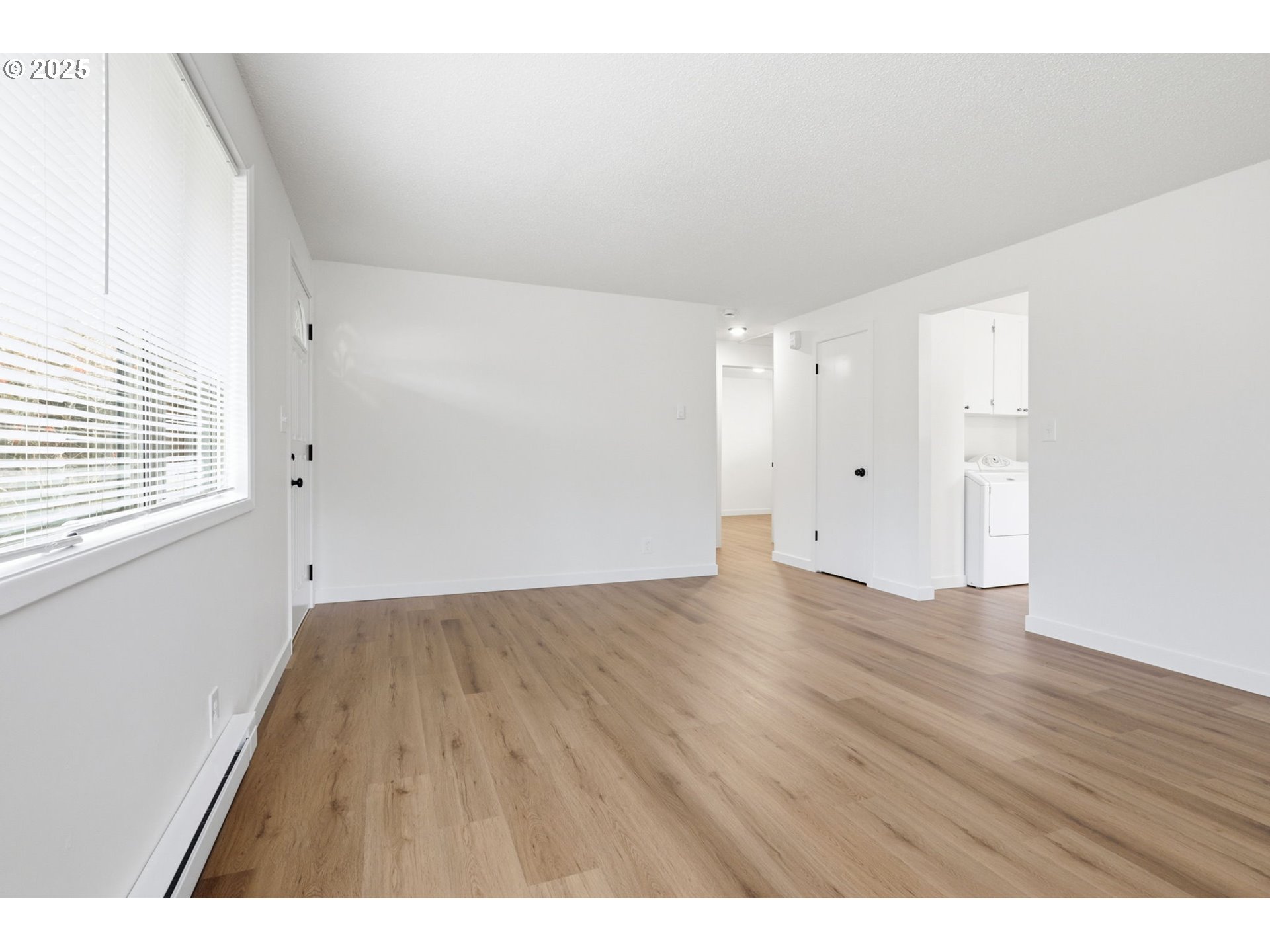117 North 9th Avenue Ridgefield, WA 98642 - Photo 9 of 47 a view of an empty room with wooden floor and a window